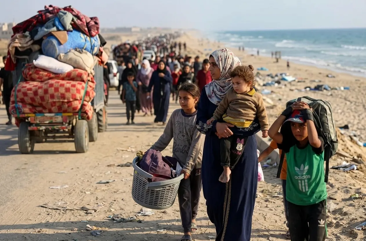 A child crosses standing water beside a displacement camp in Gaza